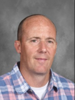 Allen Brydges is wearing a plaid dress shirt