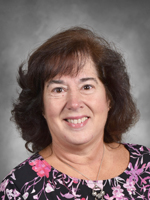 Joanne DeVito is wearing a black shirt with a flower print